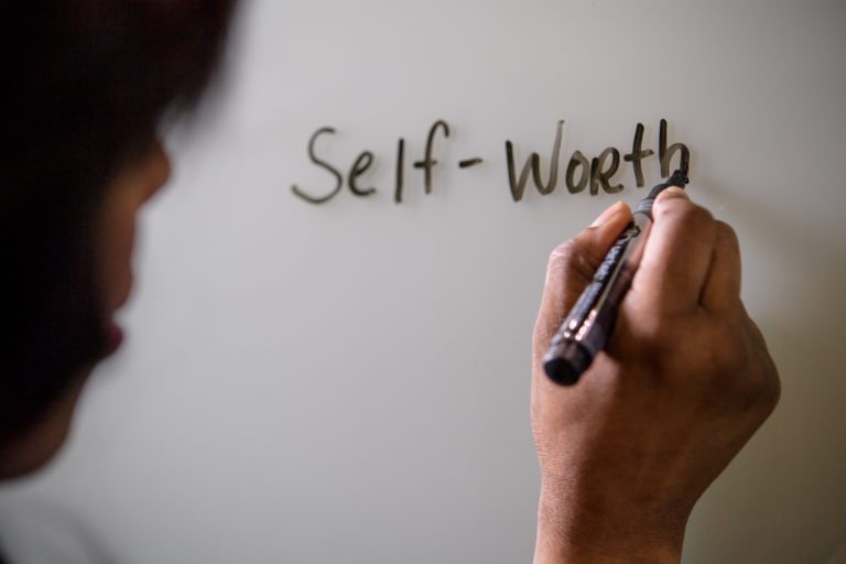 Self-worth written by Sandy Linda on a white board.